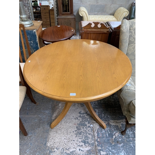 73 - A modern oak and beech circular pedestal dining table - approx. 74cm high x 100cm diameter