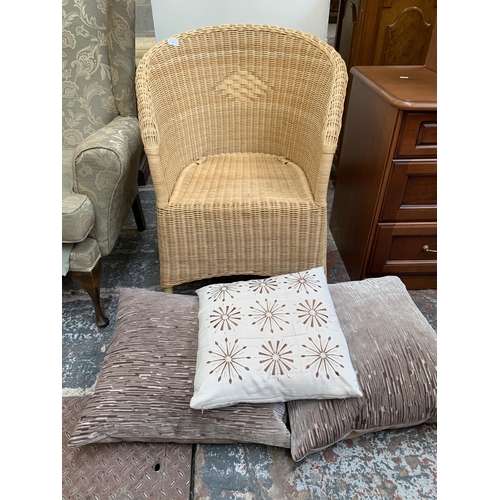 75 - A wicker and cane armchair with cushions