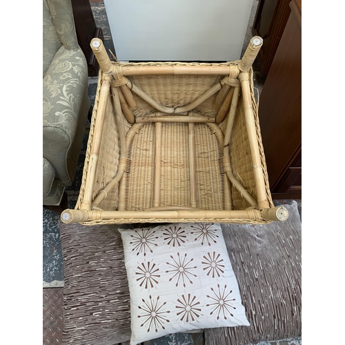 75 - A wicker and cane armchair with cushions