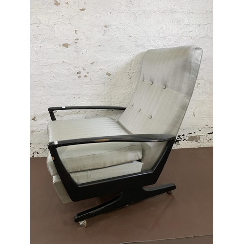 78B - A mid 20th century Parker Knoll PK1020 ebonised and fabric upholstered reclining armchair