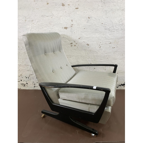 78B - A mid 20th century Parker Knoll PK1020 ebonised and fabric upholstered reclining armchair