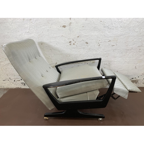 78B - A mid 20th century Parker Knoll PK1020 ebonised and fabric upholstered reclining armchair