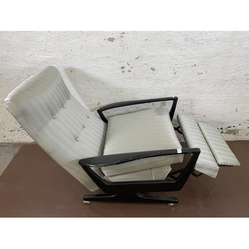 78B - A mid 20th century Parker Knoll PK1020 ebonised and fabric upholstered reclining armchair