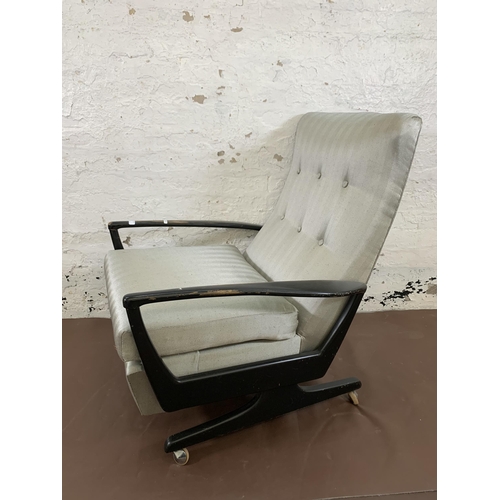 78C - A mid 20th century Parker Knoll PK1020 ebonised and fabric upholstered reclining armchair