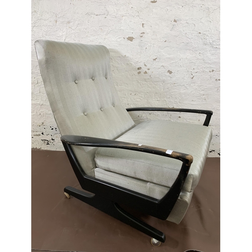 78C - A mid 20th century Parker Knoll PK1020 ebonised and fabric upholstered reclining armchair