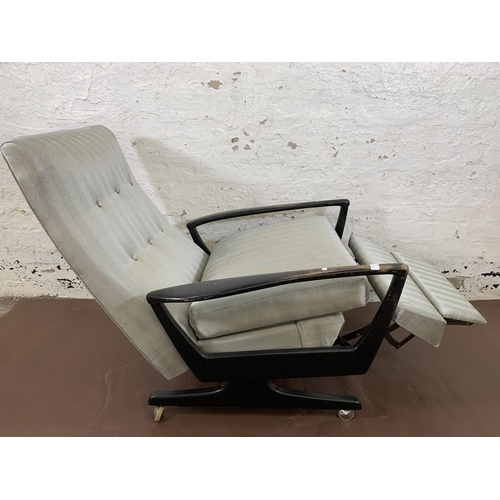 78C - A mid 20th century Parker Knoll PK1020 ebonised and fabric upholstered reclining armchair