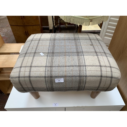 81 - A modern tartan fabric upholstered footstool on turned beech supports