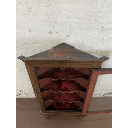 84 - A George III oak corner cabinet with brass H hinges and later added mahogany supports