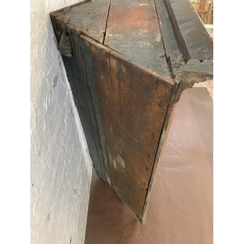 84 - A George III oak corner cabinet with brass H hinges and later added mahogany supports