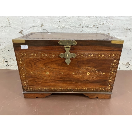 85 - An Indian brass and copper inlaid carved hardwood twin handled chest - approx. 41cm high x 61cm wide... 