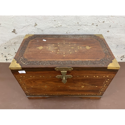 85 - An Indian brass and copper inlaid carved hardwood twin handled chest - approx. 41cm high x 61cm wide... 