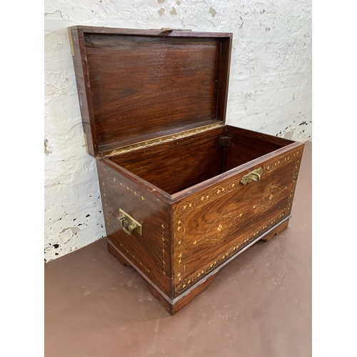 85 - An Indian brass and copper inlaid carved hardwood twin handled chest - approx. 41cm high x 61cm wide... 