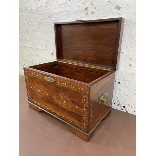 85 - An Indian brass and copper inlaid carved hardwood twin handled chest - approx. 41cm high x 61cm wide... 