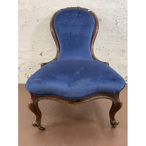 96 - A Victorian carved mahogany and blue fabric upholstered spoon back nursing chair