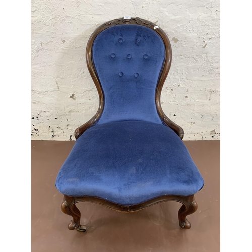 96 - A Victorian carved mahogany and blue fabric upholstered spoon back nursing chair