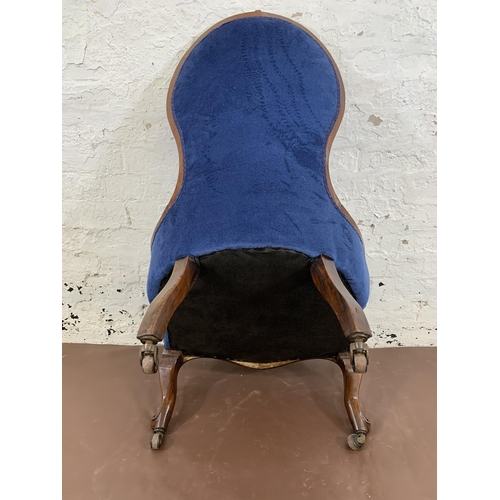 96 - A Victorian carved mahogany and blue fabric upholstered spoon back nursing chair