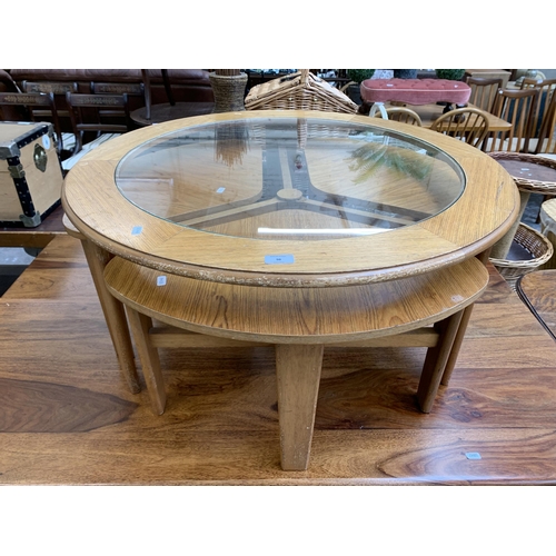 98 - A mid 20th century teak effect nest of tables - approx. 43cm high x 86cm diameter