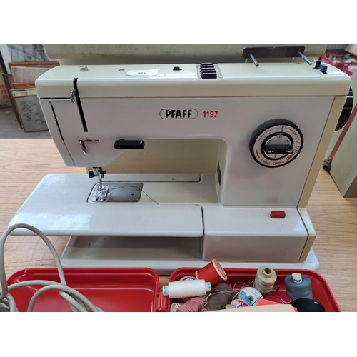 823 - A cased Pfaff 1197 electric sewing machine with foot pedal, attachments and accessories