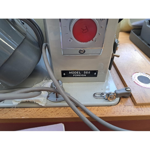 824 - A cased Jones 568 electric sewing machine with foot pedal, accessories and instruction manual