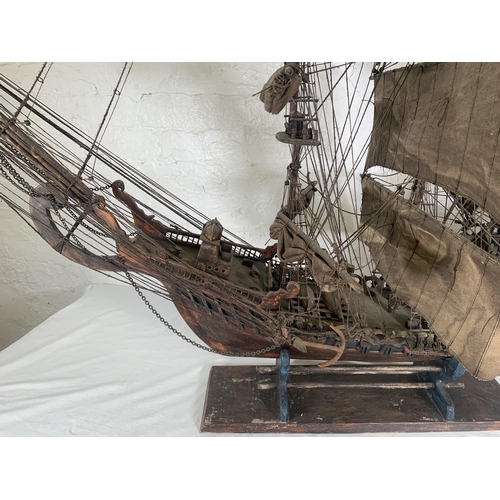 172 - A hand-painted resin and wood model ship on stand - approx. 120cm high x 156cm long