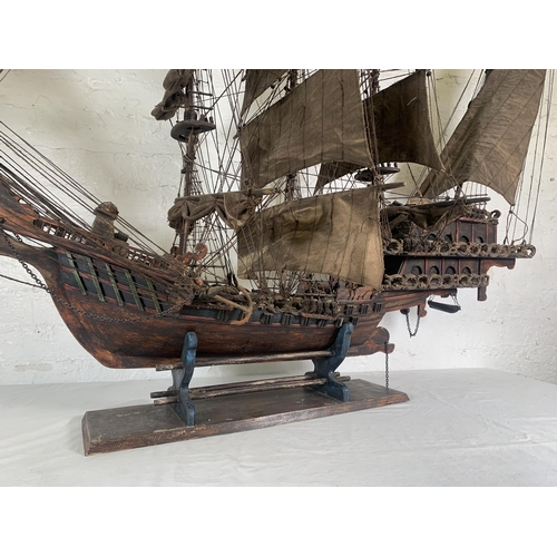 172 - A hand-painted resin and wood model ship on stand - approx. 120cm high x 156cm long