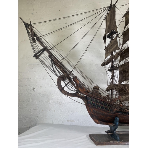 172 - A hand-painted resin and wood model ship on stand - approx. 120cm high x 156cm long