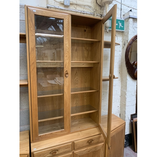 18 - An Ercol Windsor blonde elm display unit - approx. 214cm high x 181cm wide x 45cm deep