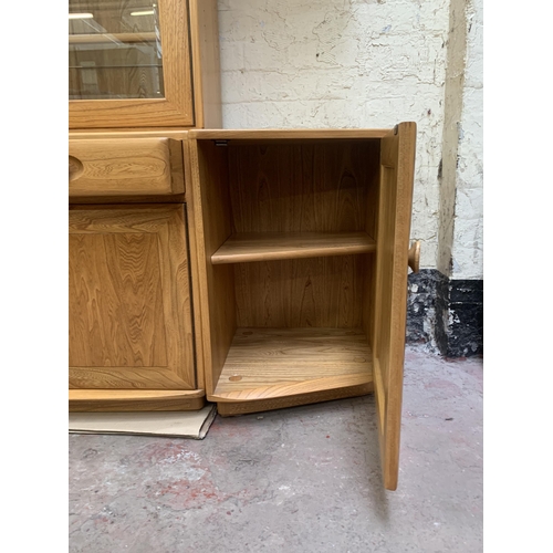 18 - An Ercol Windsor blonde elm display unit - approx. 214cm high x 181cm wide x 45cm deep