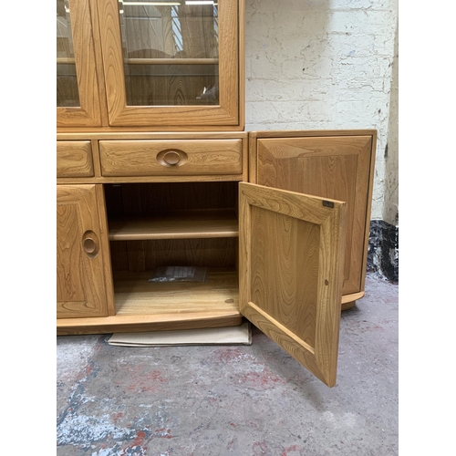 18 - An Ercol Windsor blonde elm display unit - approx. 214cm high x 181cm wide x 45cm deep