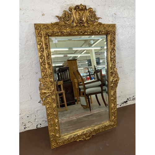 2 - A Rococo style gilt framed bevelled edge wall mirror - approx. 140cm high x 92cm wide