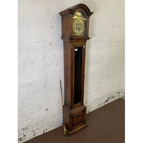 6 - A Georgian style oak cased grandmother clock with brass 'Tempus Fugit' face, key and pendulum - appr... 