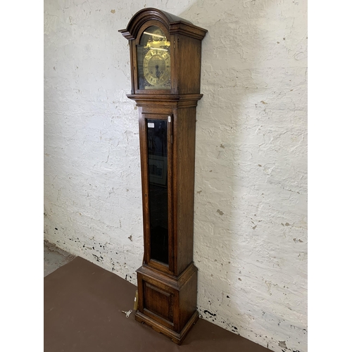 6 - A Georgian style oak cased grandmother clock with brass 'Tempus Fugit' face, key and pendulum - appr... 