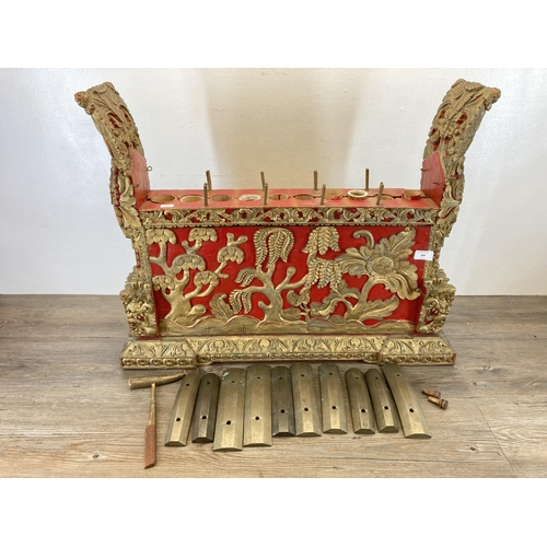 572 - An early/mid 20th century Indonesian hand carved and painted wooden Gamelan - approx. 59cm high x 72... 