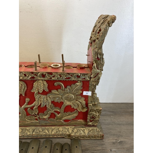 572 - An early/mid 20th century Indonesian hand carved and painted wooden Gamelan - approx. 59cm high x 72... 