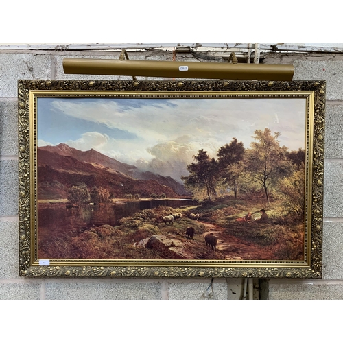 252 - A gilt framed landscape scene print with picture light - approx. 71cm high x 110cm wide