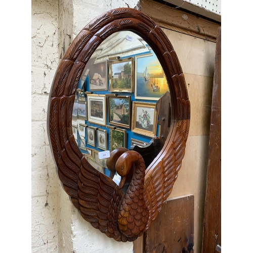 253 - A carved mahogany swan framed bevelled edge wall mirror - approx. 78cm high x 56cm wide