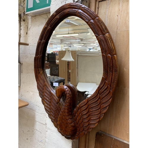 253 - A carved mahogany swan framed bevelled edge wall mirror - approx. 78cm high x 56cm wide