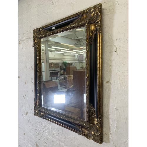 294 - A 19th century style black lacquer and gilt framed bevelled edge wall mirror - approx. 66cm high x 5... 