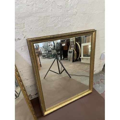 305 - Four gilt framed wall mirrors - largest approx. 109cm high x 78cm wide