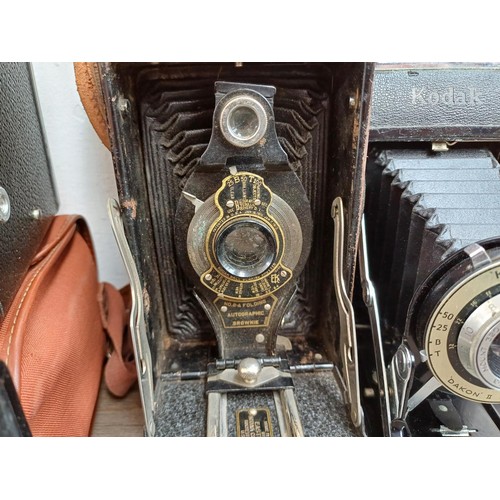 647 - Seven vintage cameras, two Haking Halina 35X compact 35mm viewfinder, one Kodak Brownie Six-20 model... 