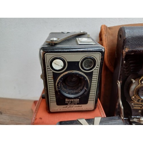 647 - Seven vintage cameras, two Haking Halina 35X compact 35mm viewfinder, one Kodak Brownie Six-20 model... 