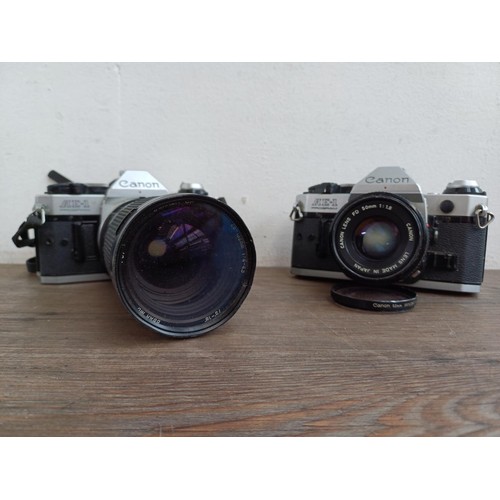 653 - Two Canon AE-1 Program 35mm SLR cameras, one fitted with Tamron SP 1:4-4.5 28-135mm lens and one fit... 