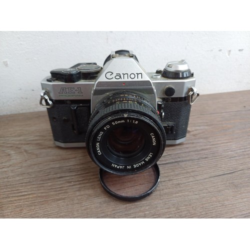 653 - Two Canon AE-1 Program 35mm SLR cameras, one fitted with Tamron SP 1:4-4.5 28-135mm lens and one fit... 