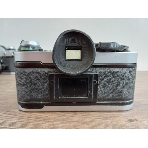 653 - Two Canon AE-1 Program 35mm SLR cameras, one fitted with Tamron SP 1:4-4.5 28-135mm lens and one fit... 