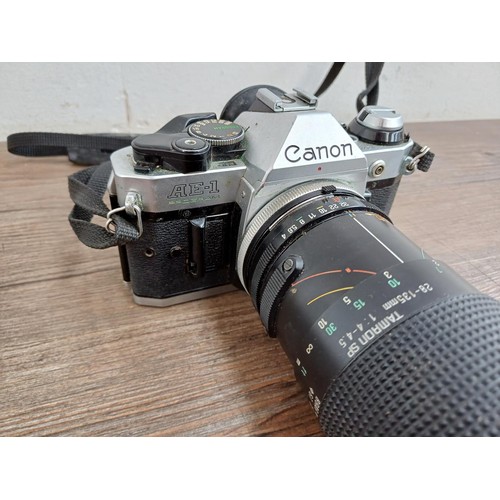 653 - Two Canon AE-1 Program 35mm SLR cameras, one fitted with Tamron SP 1:4-4.5 28-135mm lens and one fit... 