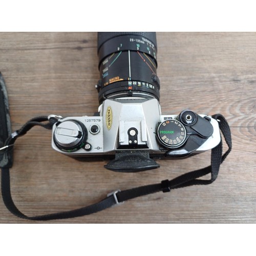 653 - Two Canon AE-1 Program 35mm SLR cameras, one fitted with Tamron SP 1:4-4.5 28-135mm lens and one fit... 