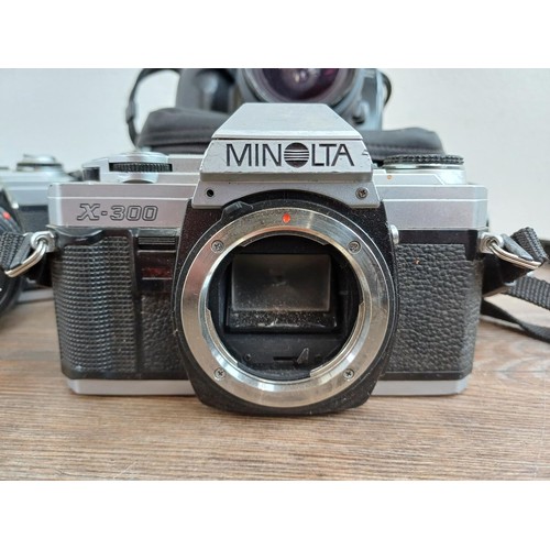 657 - Four Minolta 35mm SLR cameras, one X-300 body, one X-300 fitted with MD1:1.7 50mm lens, one 5000 fit... 