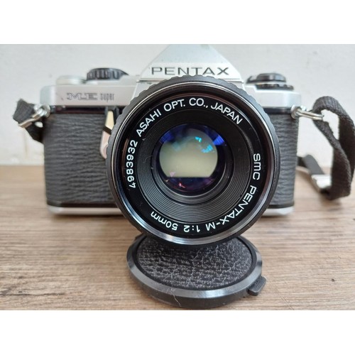 668 - A cased Pentax ME Super 35mm SLR camera fitted with Pentax-M 1:2 50mm lens