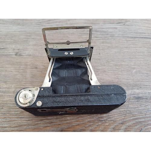 670 - A cased 1930s Houghton-Butcher Ensign Midget A/D model 33 strut folding miniature camera for Ensign ... 