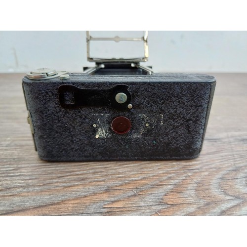 670 - A cased 1930s Houghton-Butcher Ensign Midget A/D model 33 strut folding miniature camera for Ensign ... 